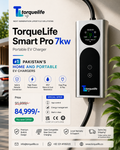 TorqueLife Smart Pro 7kw portable EV charger shown mounted on a wall, with a large promotional ad layout in Urdu and English. The charger is silver and black with a digital display screen, and the ad includes product features, pricing, and certification icons.